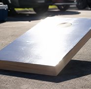 Glare washing across a cornhole board on a sunny afternoon